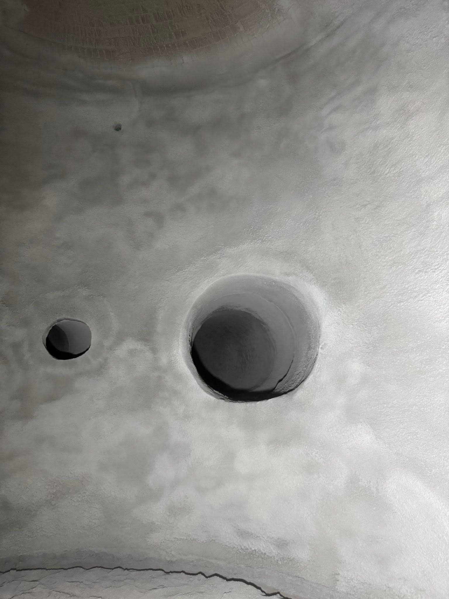 Gunned refractory lining inside a duct with two round penetrations